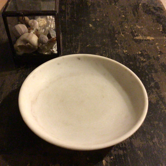 This round  shallow marble dish is perfect to keep on your bedside table.  